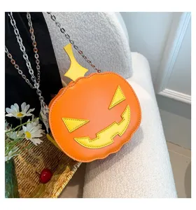 Close-up of a unique Halloween pumpkin crossbody bag with chain strap and cute Jack-o'-lantern details.
