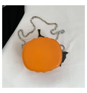 Close-up detail of the creative Halloween pumpkin shaped crossbody bag with metallic chain.