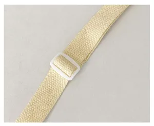 Close-up detail of beige woven bag strap with white plastic adjustable buckle and neat finish.