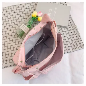 Pink floral canvas crossbody bag, large capacity messenger bag for students and daily use.
