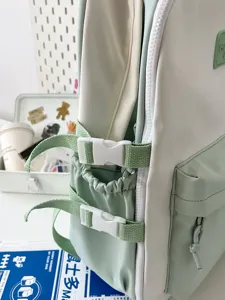 Japanese style mint green and white backpack student school bag side detail view display.