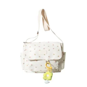 Canvas floral messenger bag for women, cute shoulder crossbody bag with flower pendant.
