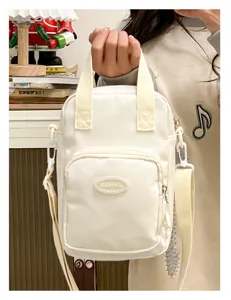Small white canvas crossbody bag for cotton dolls and daily casual wear with shoulder strap.