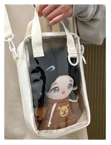 Detail shot of a transparent front ita bag showcasing a cute 20cm plush cotton doll inside.