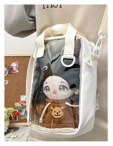 Detail view of a white 20cm cotton doll ita bag with transparent front window and cute bear.