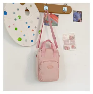 Kawaii pink crossbody shoulder bag for women, cute ins style canvas bag with front pocket.