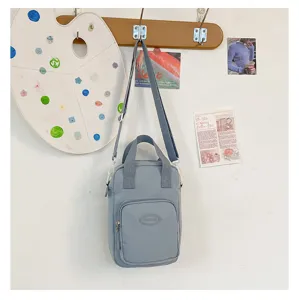 Grey canvas crossbody bag with front pocket, cute plush doll bag for daily casual wear.
