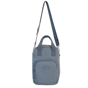 Japanese style small crossbody bag with handles and front zipper pocket, light grey blue.