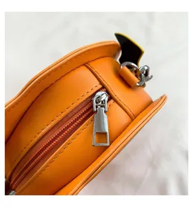 Orange Halloween pumpkin bag detail, close-up view showing smooth PU leather and metal zipper.