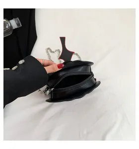 Halloween creative gothic black crossbody bag with metal chain strap and unique bat shape.