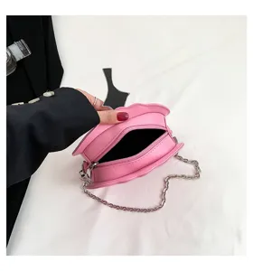 Pink pumpkin shaped shoulder bag with metal chain detail. Compact crossbody bag for women.