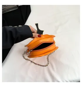 Halloween pumpkin shape shoulder bag detail, orange PU leather with metal chain strap.