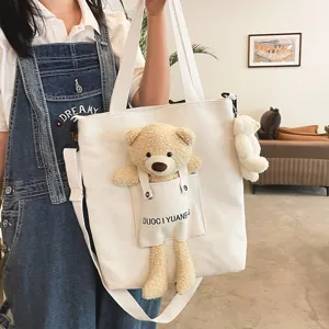 Bolso bandolera de lona lindo para mujeres con muñeco de oso de peluche, estilo japonés casual.