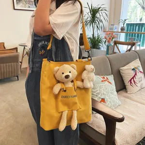 Bolsa de lona para mujer bonita con adorable colgante de muñeco de oso de peluche y bolsillo.