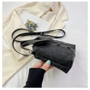 Gedetailleerd overzicht van de creatieve kledingvormige handtas met uniek knopontwerp voor mode.