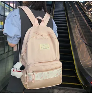 Pink floral patchwork backpack for school students and daily commute with cute puppy pendant.