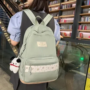 Mint green school backpack for women, cute floral patchwork casual daypack with plush pendant.