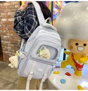 Casual light blue transparent window backpack with cute plush pendants for daily campus life.