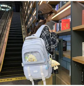 Cute light blue ita backpack with transparent window and plush pendant for school students.