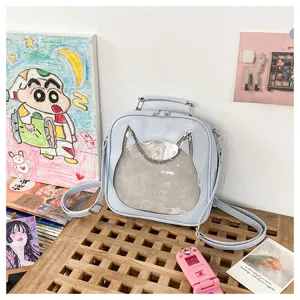 Clear transparent window detail of cute cat ear ita bag showcased on rustic wooden display