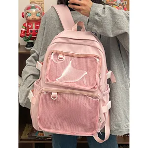 Pink ita backpack front detail showing clear mesh pockets, ideal for pins and badges display.