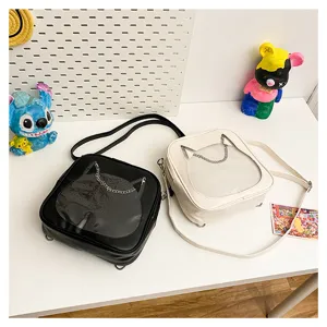 Close-up detail of cute cat ita bag, transparent window doll bag, PU leather mini backpack.