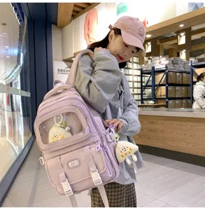 Detail view of the cute lavender canvas student backpack with transparent window and plush pendant.