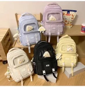 Cute large capacity student canvas backpack with transparent front pocket and plush pendant.