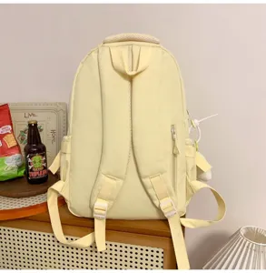 Casual minimalist canvas student backpack in soft yellow, perfect for daily campus use and travel.