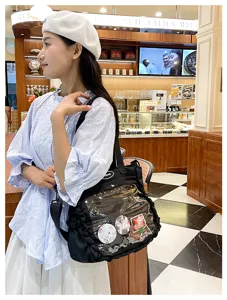 Cute Japanese anime style black ita bag with clear window and ruffles for daily use.