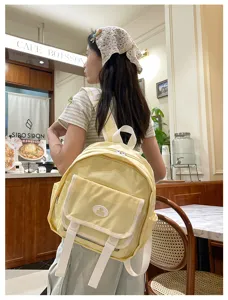 Cute yellow mini backpack for women, Japanese JK style casual daypack with front pocket design.
