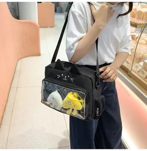 Detailed view of cute black cat pain bag with transparent display window and plush charms.