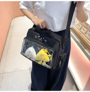 Cute cat ita bag with clear window and plush pendants, versatile student messenger bag.