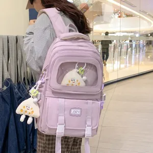 Stylish purple canvas school backpack with transparent window and cute pendant for daily use.