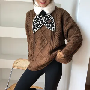 Cozy winter cable knit sweater set with plush furry collar and stylish patterned scarf.