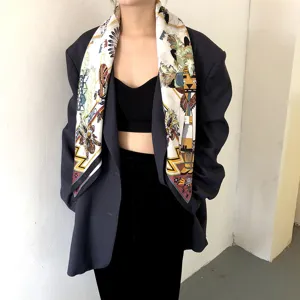 Luxury silk square scarf with ethnic totem print, elegant styling accessory for women.