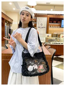 Black Japanese style canvas ita bag with clear window for anime badges and crossbody strap.