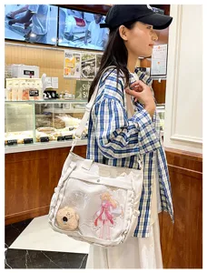 Cute Japanese anime canvas ita bag with clear window, plush charm and crossbody strap.