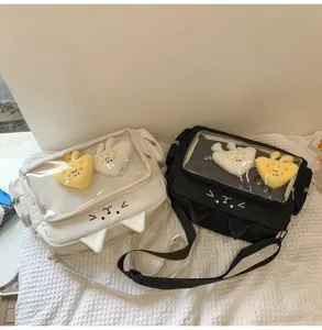 Close-up of cute cat ita bags in black and white with clear window and cute plush charms.