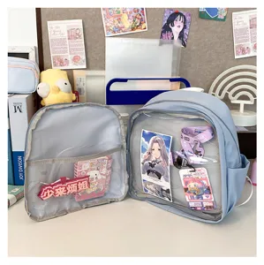 Detailed view of light blue ita backpack with transparent front pocket, anime inserts.
