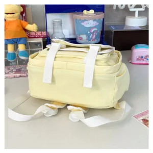 Detail view of the yellow JK uniform ita backpack with clear window and white straps.