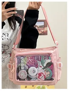 Pink canvas ita bag detail with clear front pocket for cute anime pins and badges display.