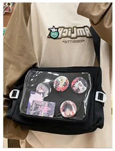Black canvas ita bag with transparent window for anime badges and cross-body shoulder bag.