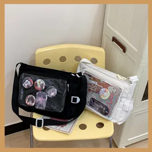 Close-up detail of canvas ita bag with transparent pocket displaying anime badges and cute inserts.