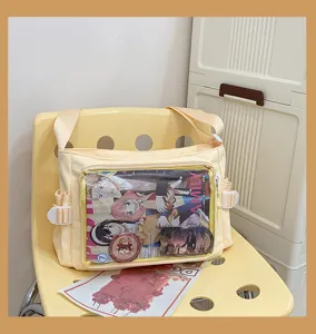 Yellow canvas ita bag with clear window and cute anime prints for women daily use