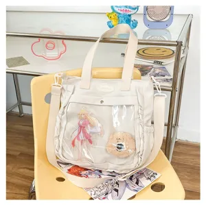 Cute Japanese style white canvas ita bag with clear front pocket design for cute anime fans.