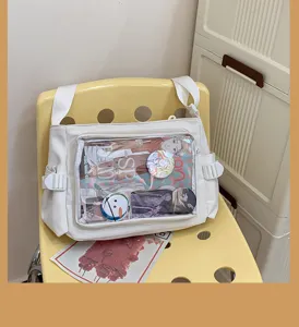 White canvas ita bag with transparent window, perfect for anime pins and daily school wear.