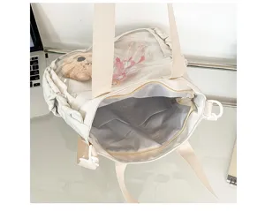 Canvas ita bag detail showcasing transparent window pocket, inner lining, and compartments.