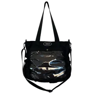 Detail shot of the black ita bag featuring a clear front display pocket and adjustable strap.