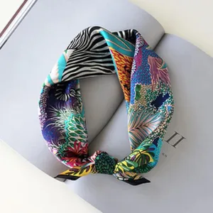 Multicolor silk square scarf with vibrant botanical and geometric print, stylish accessory.